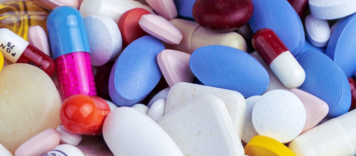 white blue and orange medication pill