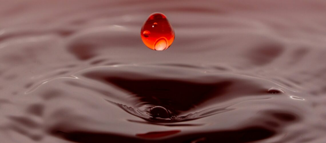 A drop of water with a red droplet